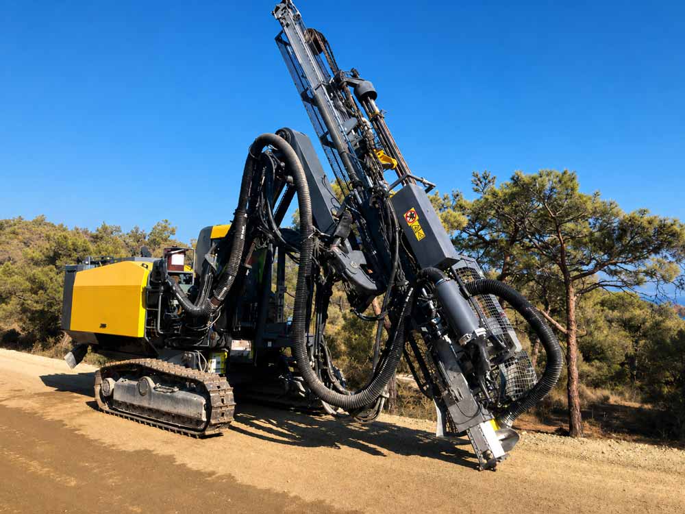 1780458582934566.jpg DTH-drilling-rig-operating-with-DTH-hammer-and-bit-assembly-entering-borehole-at-mining-site.jpg